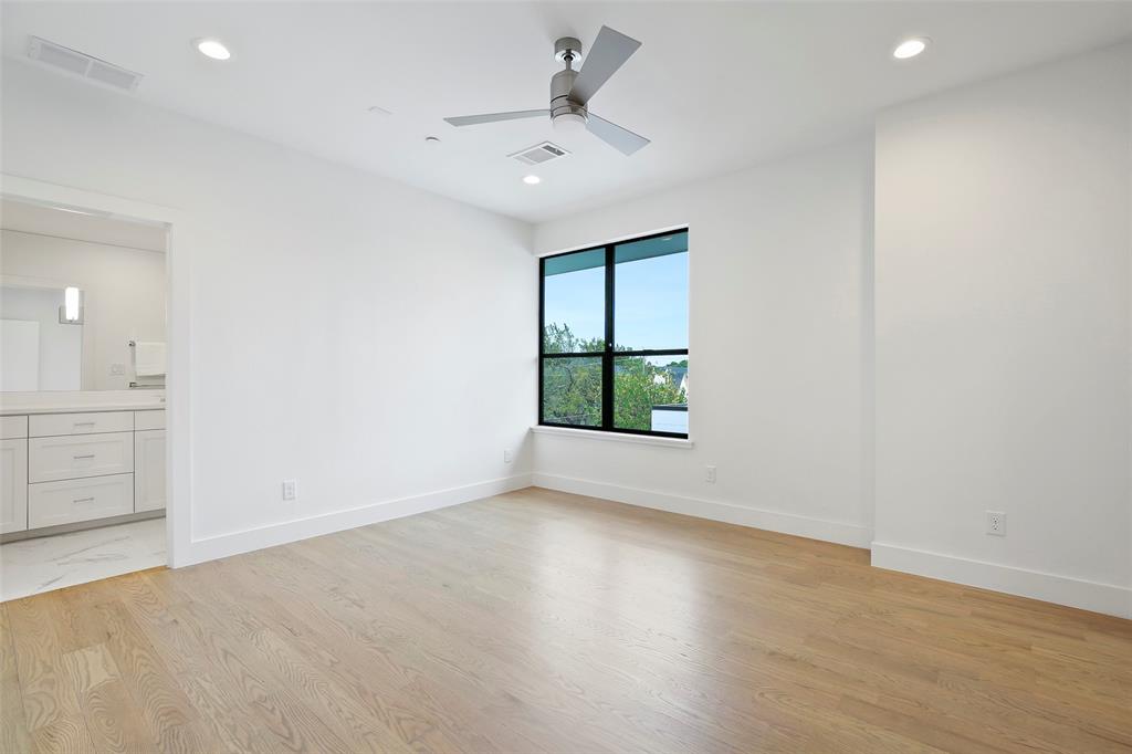 2307 Kirby Street, Unit B Dallas, TX 75204 - Photo 14 of 28 wooden floor in an empty room with a window