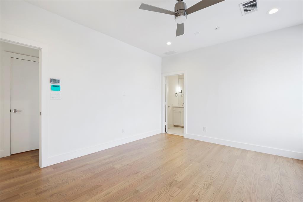 2307 Kirby Street, Unit B Dallas, TX 75204 - Photo 16 of 28 an empty room with wooden floor and a ceiling fan