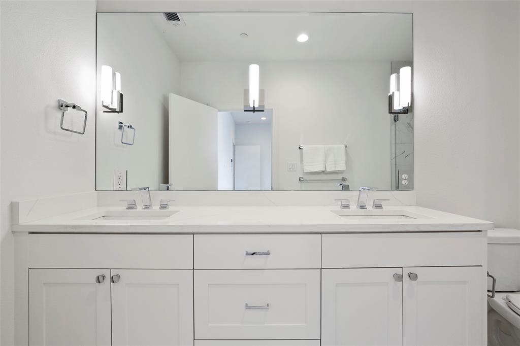 2307 Kirby Street, Unit B Dallas, TX 75204 - Photo 18 of 28 a bathroom with double sink and a mirror