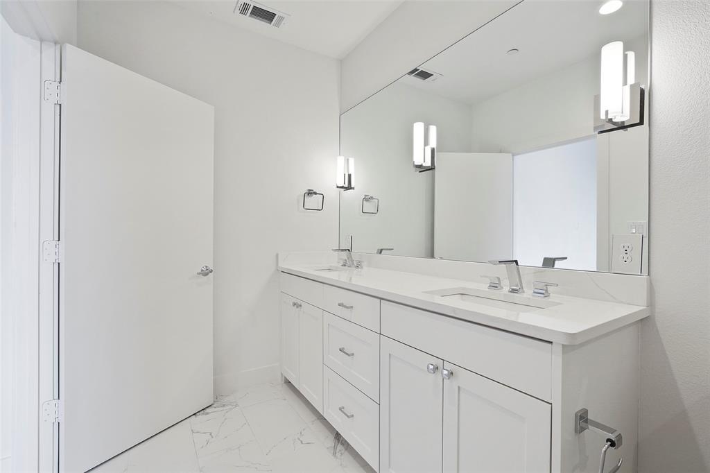 2307 Kirby Street, Unit B Dallas, TX 75204 - Photo 19 of 28 a bathroom with a sink and a mirror