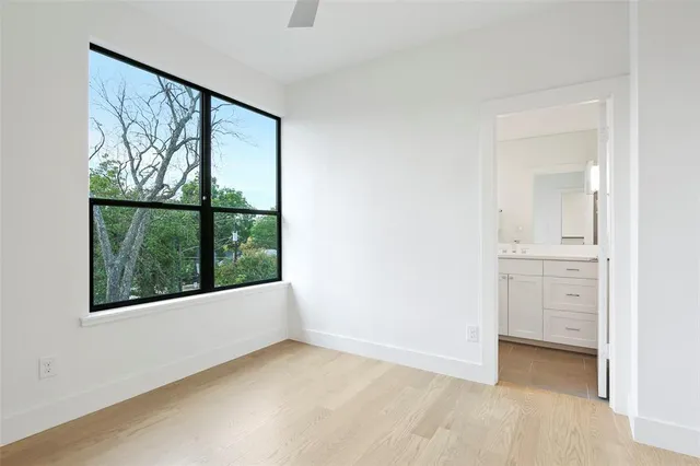 an empty room with windows and closet