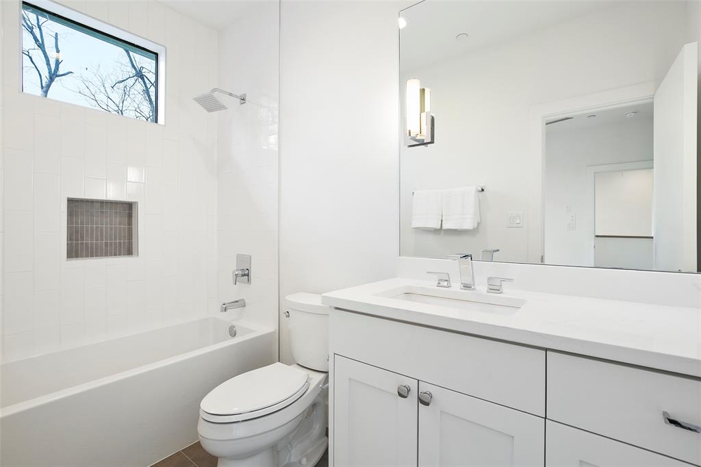 2307 Kirby Street, Unit B Dallas, TX 75204 - Photo 23 of 28 a bathroom with a sink a toilet and shower