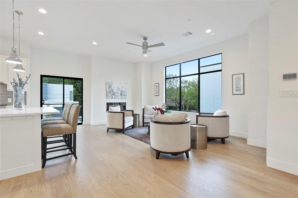 2307 Kirby Street, Unit B Dallas, TX 75204 - Photo 6 of 28 a living room with furniture a large window and wooden floor
