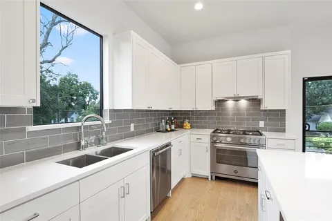 a kitchen with a sink cabinets and stainless steel appliances