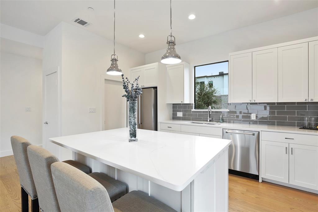 2307 Kirby Street, Unit B Dallas, TX 75204 - Photo 10 of 28 a kitchen with a table chairs sink and cabinets