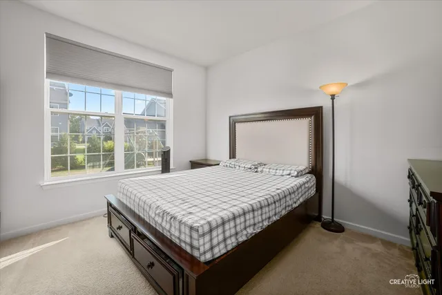 a bed sitting in a bedroom next to a window