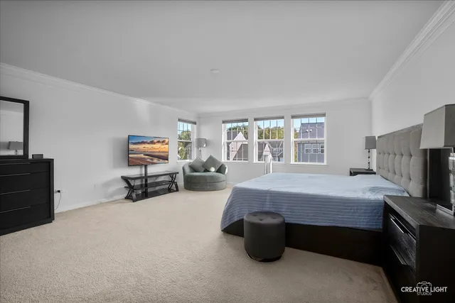 a bedroom with furniture and a flat screen tv