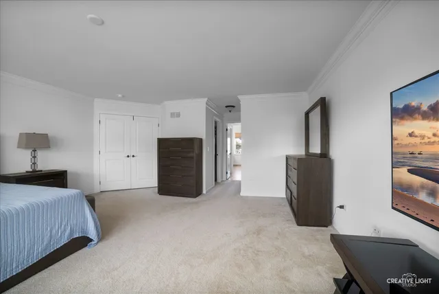 a bedroom with a bed and a television