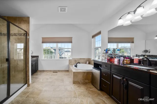 a kitchen that has a lot of cabinets and wooden floor