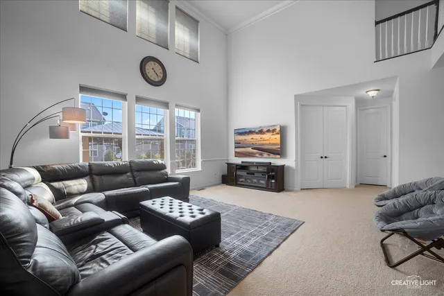a living room with furniture a large window and a rug