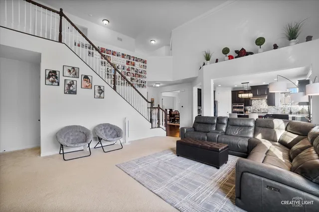 a living room with furniture and a chandelier