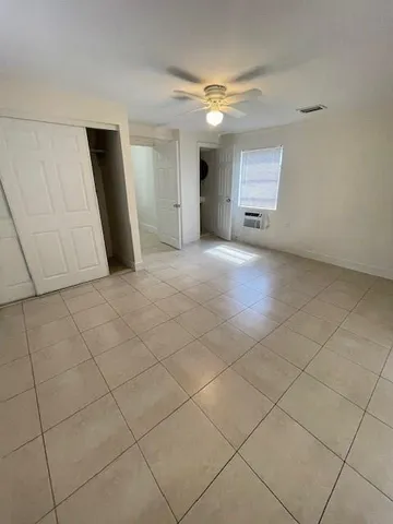 a view of a livingroom with an empty space and a window