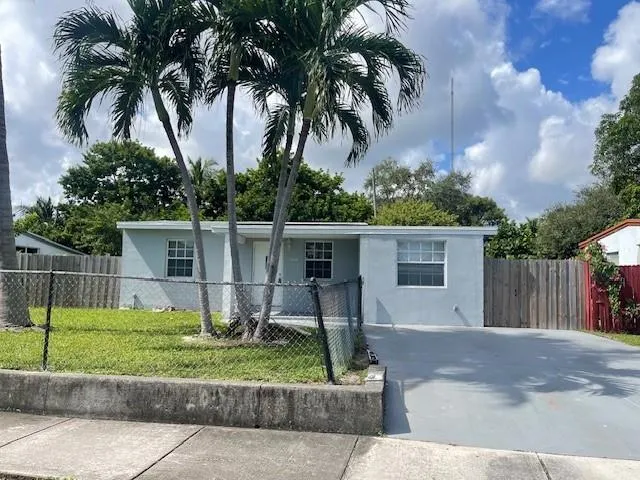 a front view of a house with garden and patio