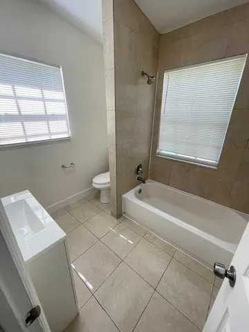 a bathroom with a bathtub and window