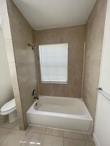 a bath tub sitting next to a white toilet