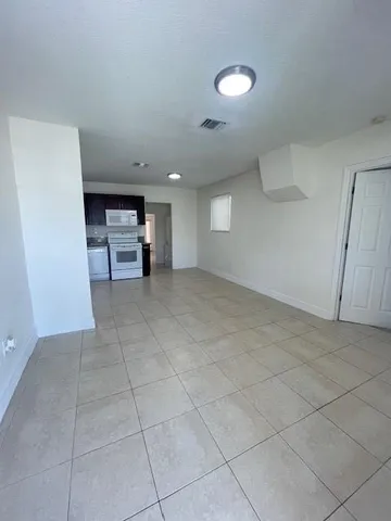 an empty room with fireplace and windows