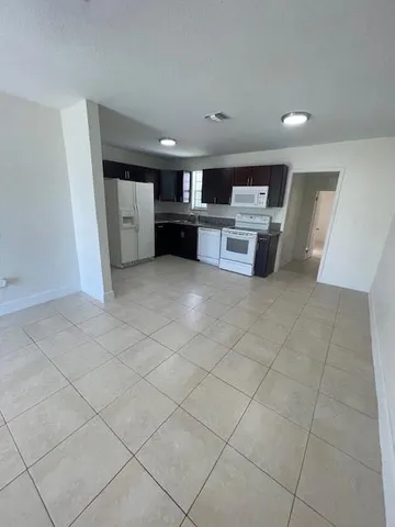 a view of a kitchen with furniture and cabinets