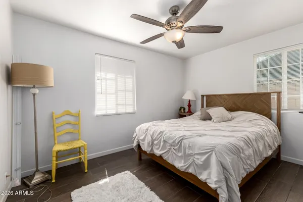 a bedroom with a bed a couch and a window