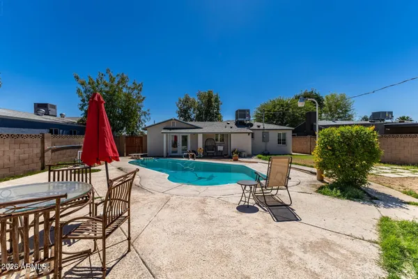 a view of a chair and table in the patio