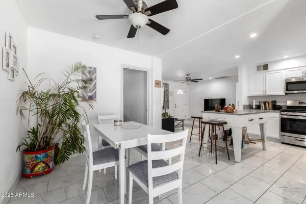 a view of a dining room with furniture and a potted plant