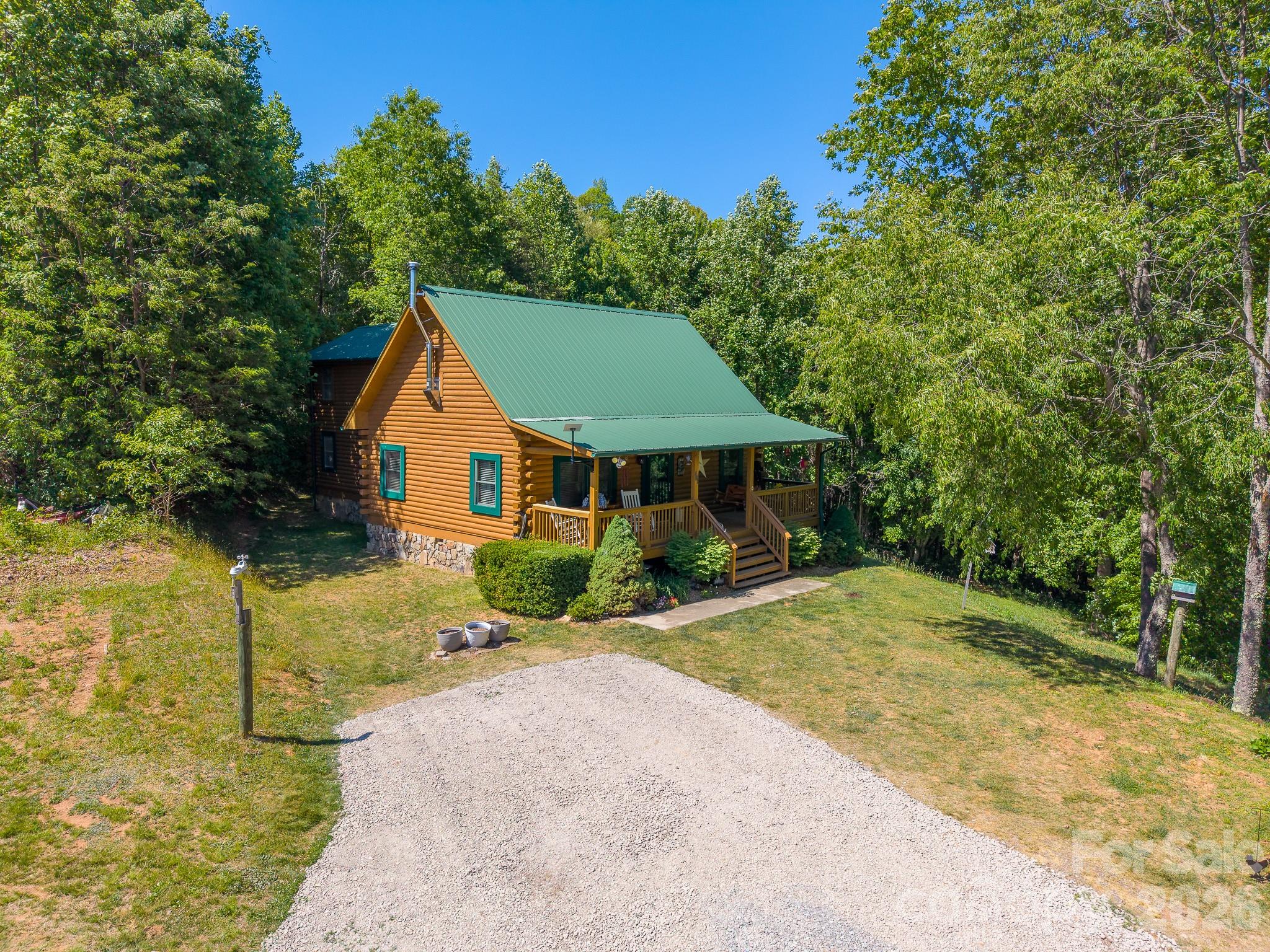 451 Rustic Ridge Drive Canton, NC 28716 - Photo 2 of 44 a front view of a house with a yard
