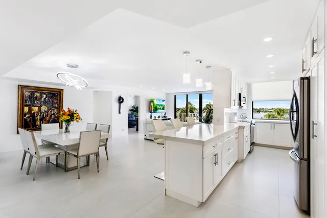 a view of kitchen with kitchen island white cabinets and stainless steel appliances