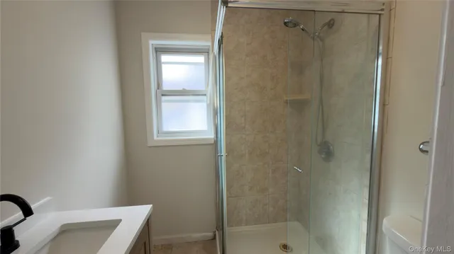 a bathroom with a shower and a sink
