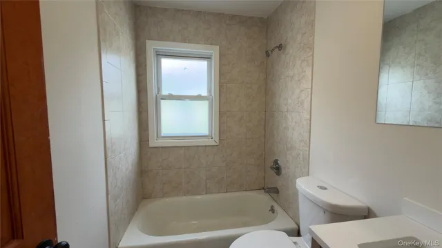 a bath room with a toilet and a bath tub