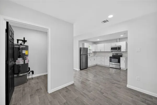 a view of a kitchen with wooden floor and a sink