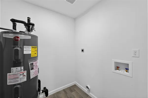 a view of storage and utility room with a window