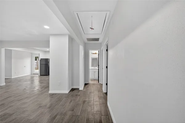 a view of a hallway with wooden floor