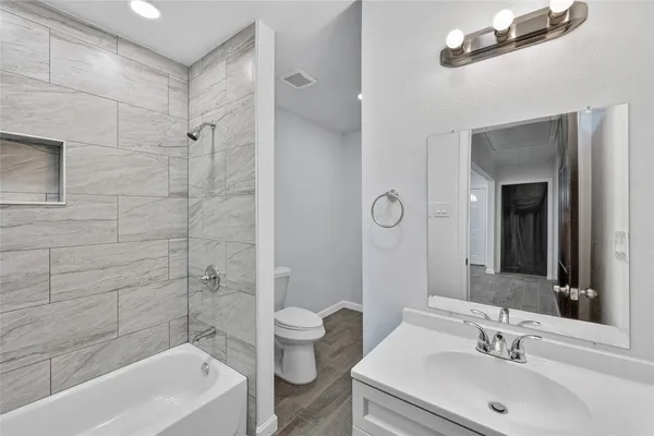 a bathroom with a sink mirror toilet and bathtub