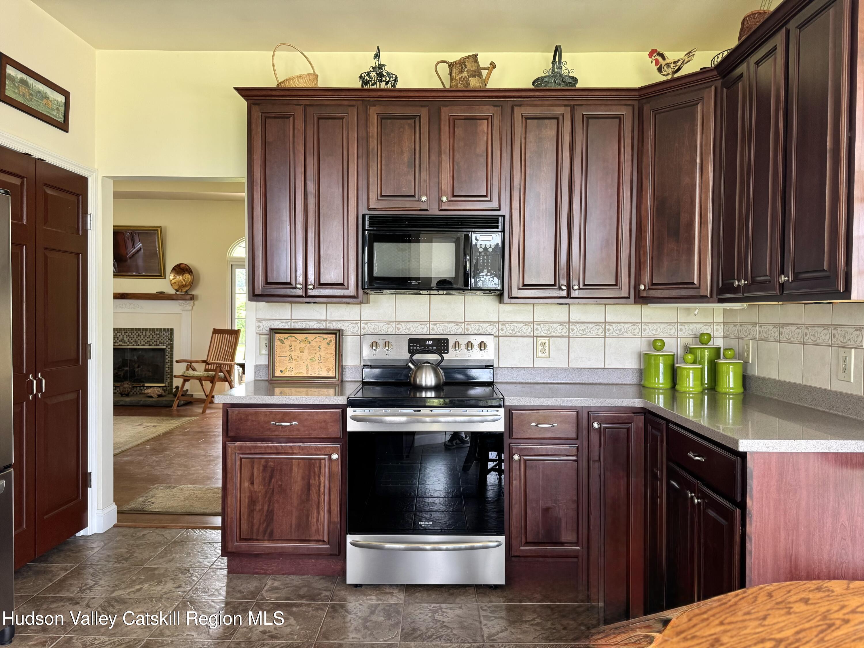 2914 Sleepy Hollow Road Athens, NY 12015 - Photo 20 of 39 a kitchen with kitchen island granite countertop wooden cabinets stainless steel appliances and a counter space
