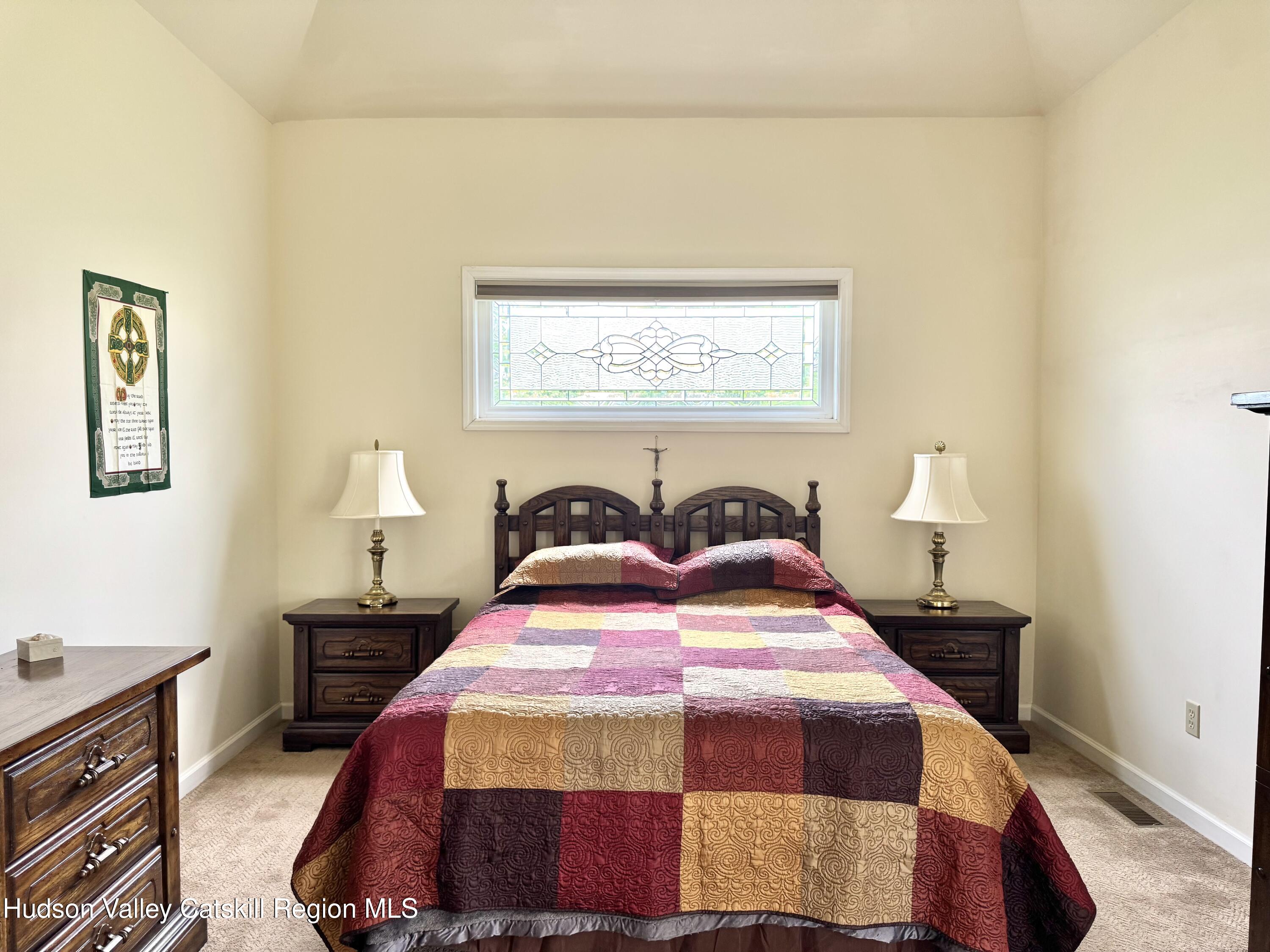 2914 Sleepy Hollow Road Athens, NY 12015 - Photo 24 of 39 a bedroom with a bed and a lamp on dresser