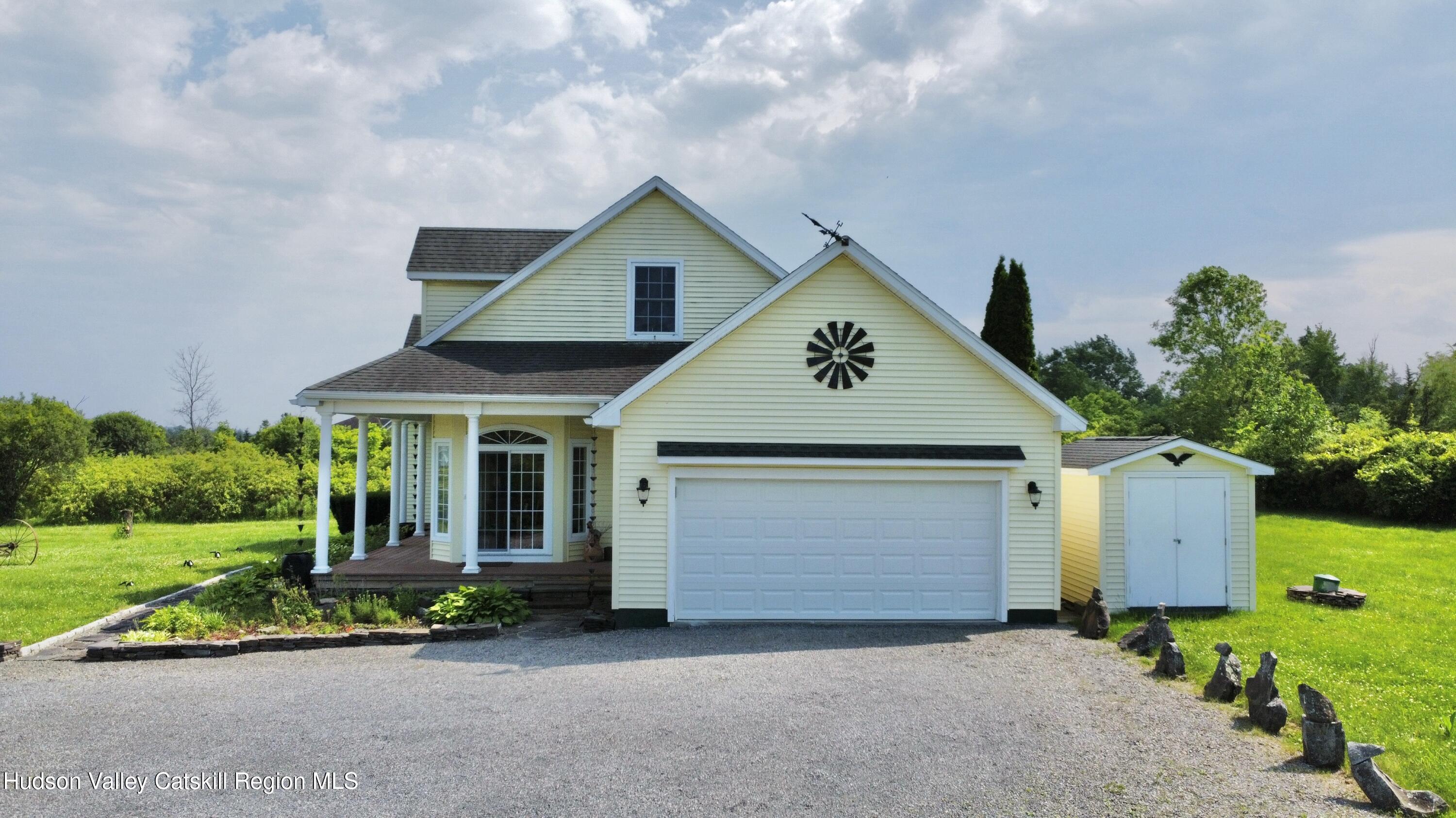 2914 Sleepy Hollow Road Athens, NY 12015 - Photo 3 of 39 a front view of a house with a yard and garage