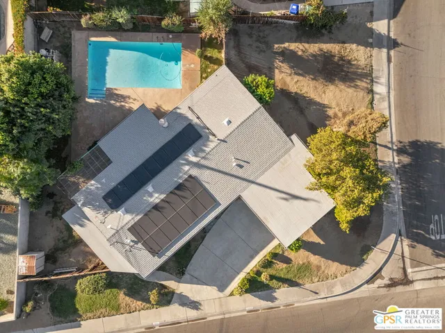 an aerial view of a house with a yard