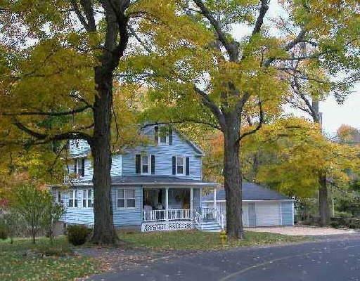 31 Ramapoo Road Ridgefield, CT 06877 - Photo 1 of 1 a front view of a house with a tree and a big yard