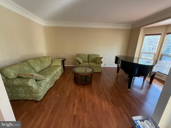 a living room with furniture and a piano