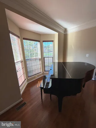 a view of a workspace with furniture and wooden floor