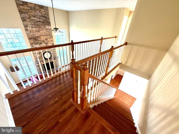 a spacious bedroom with a bed and wooden floor