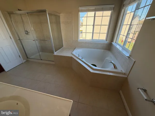 a view of bathroom with a bathtub and sink