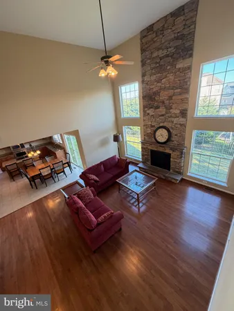 a livingroom with furniture a fireplace and wooden floor