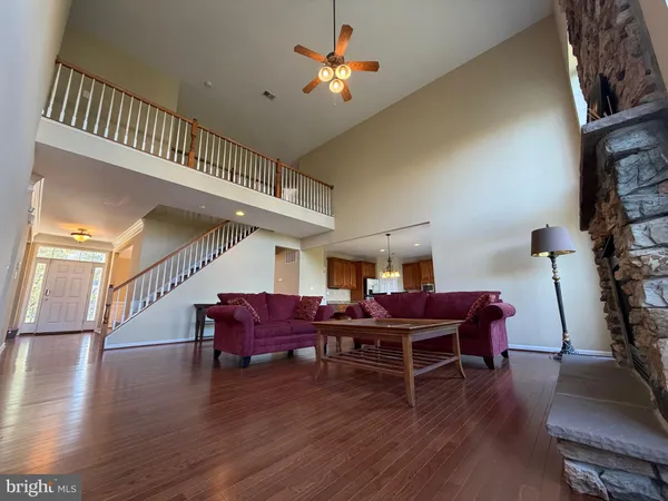 a living room with furniture window and wooden floor