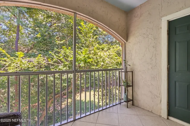 a kitchen with stainless steel appliances kitchen island granite countertop a refrigerator a stove a sink a dining table and chairs with wooden floor