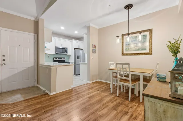 a kitchen with granite countertop a refrigerator and a stove top oven
