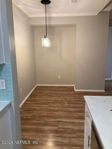 a view of a yard with plants and trees