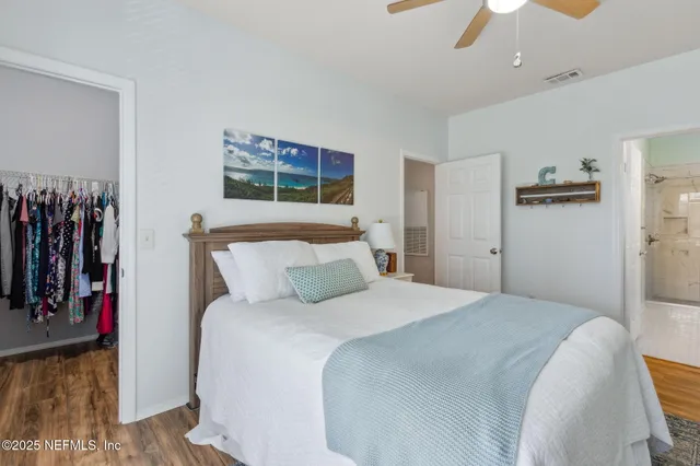 a bedroom with a bed potted plant and a window