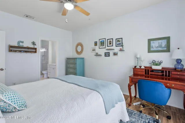 a bathroom with a toilet a sink a vanity and mirror