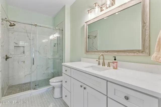 a living room with couch a flat screen tv and a large window