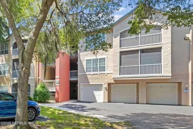 a living room with stainless steel appliances furniture a fireplace and a flat screen tv